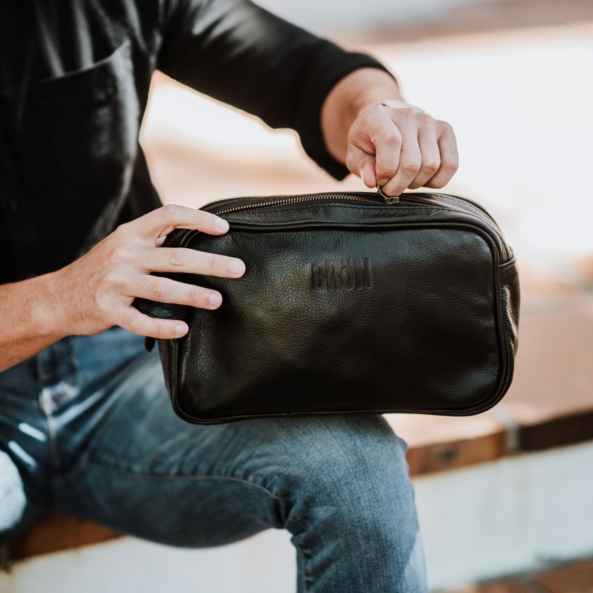 Front view of the leather toiletry bag, showcasing the top zipper.