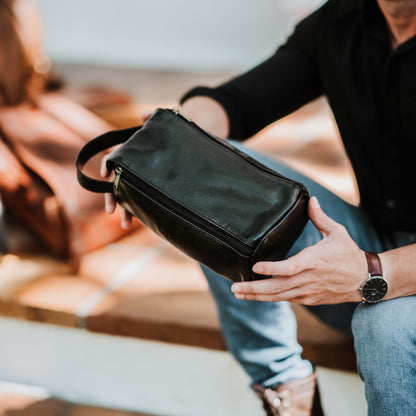 Top view of the leather toiletry bag, showcasing the handle and top zipper.