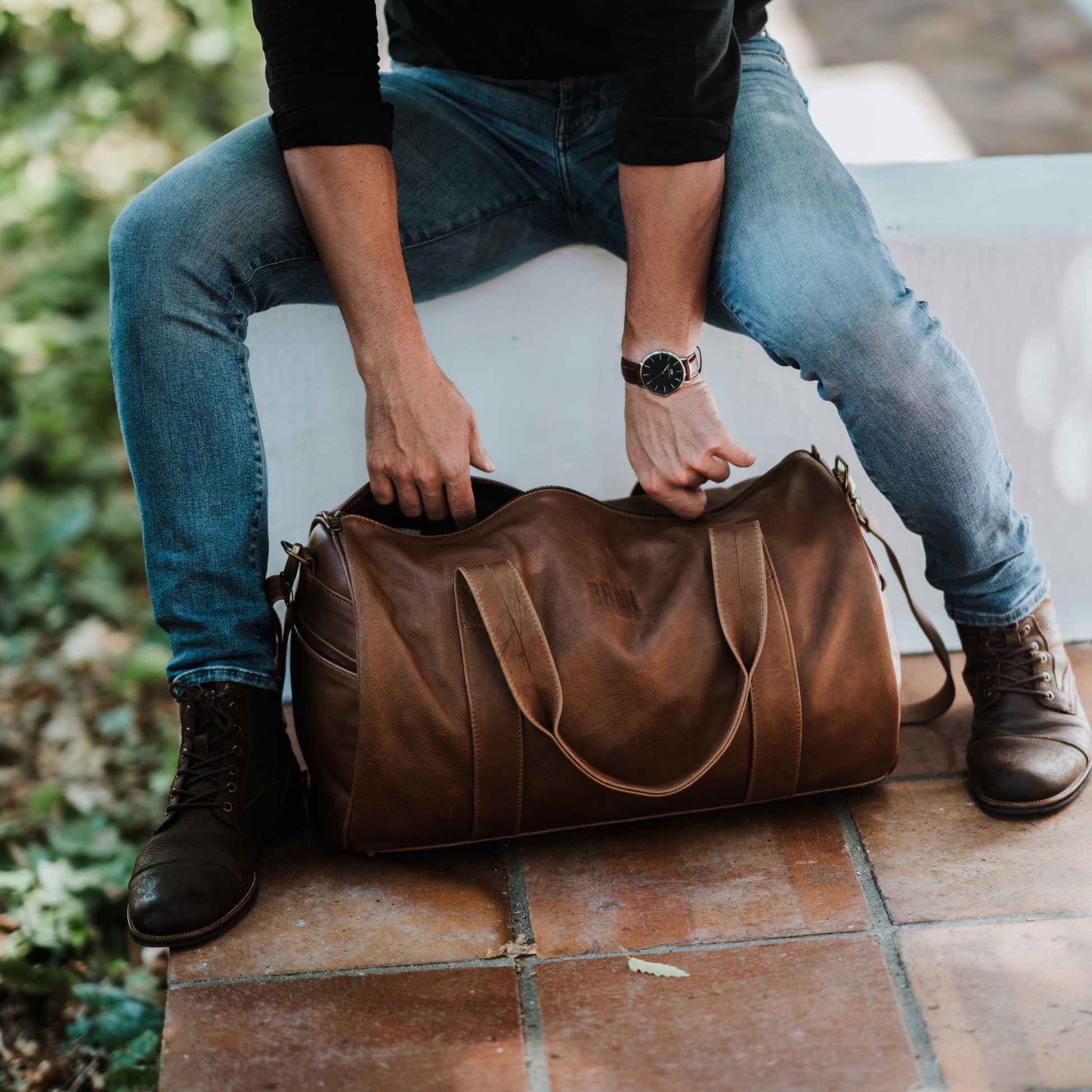 Front view of leather duffel bag, showcasing the handles.