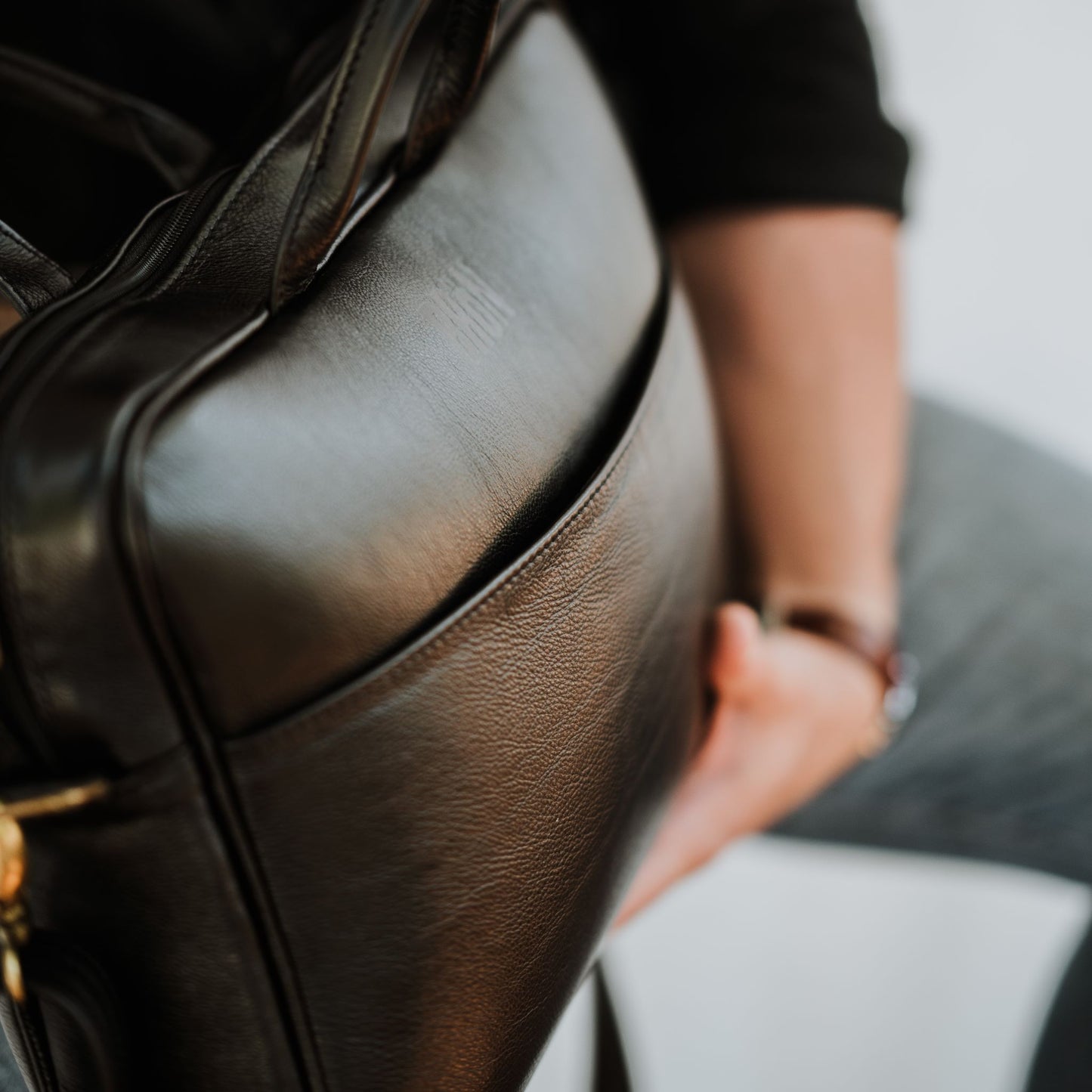 Close up front view of leather laptop bag, showcasing front sleeve pocket.