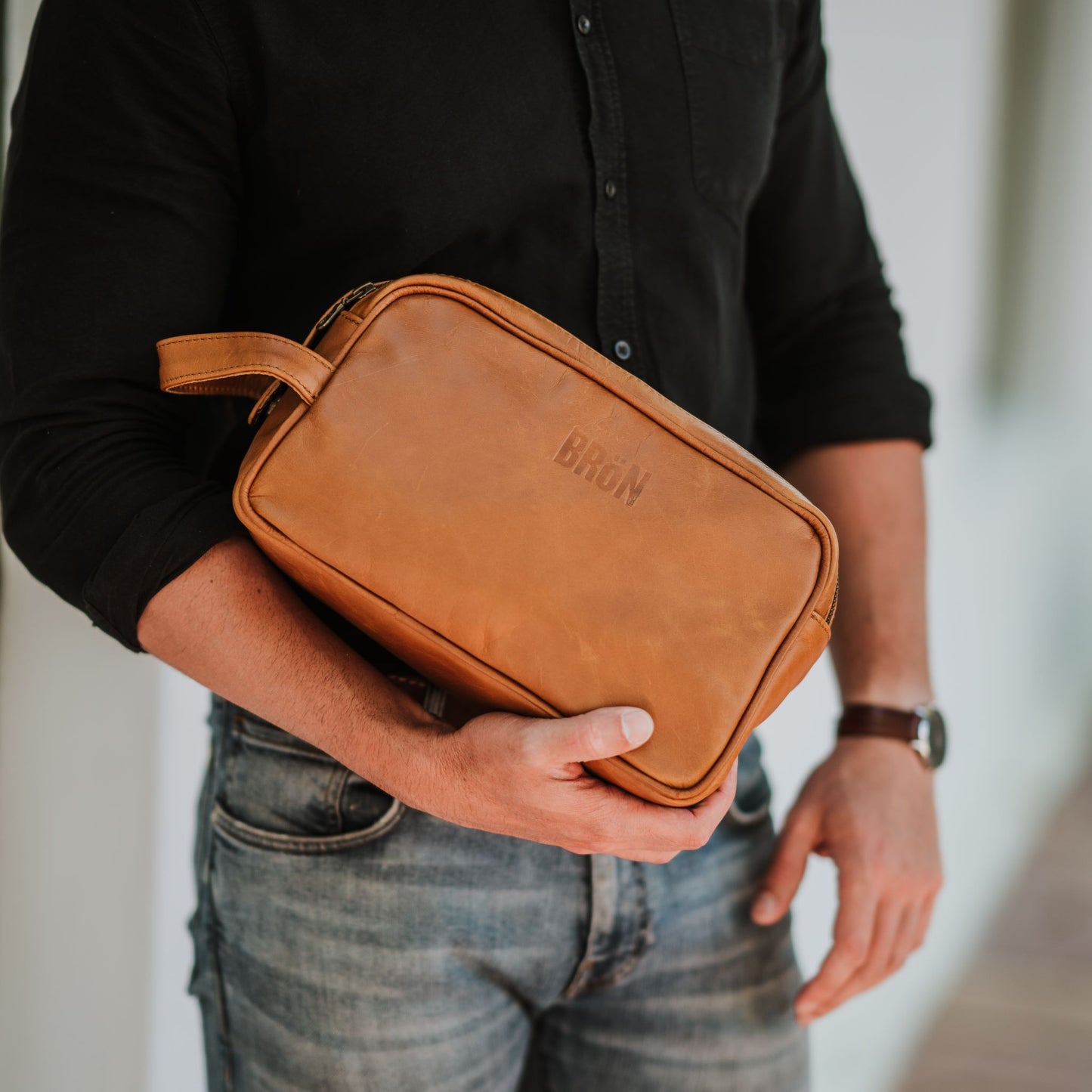 Front view of the leather toiletry bag, showcasing the handle.